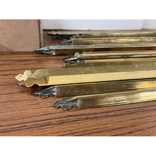 316 - A set of nineteen brass stair rods and forty fittings