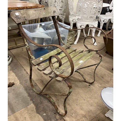 320 - A Victorian wrought iron garden chair and a pair of bench ends