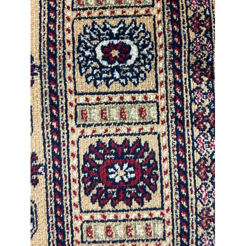 3165 - A Bokhara style gold ground anti-slip runner rug