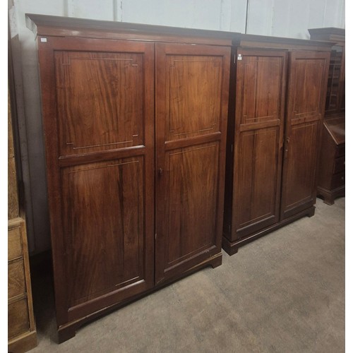 116 - A pair of Edward VII fitted mahogany two door wardrobes