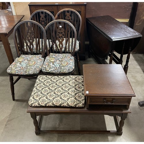 271 - An early 20th Century oak drop leaf table and four chairs, a bookcase and telephone seat