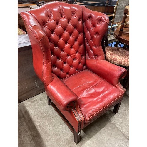 274 - A red leather Chesterfield wingback armchair