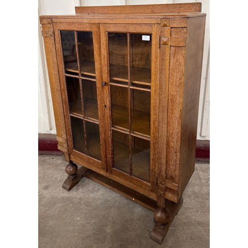 239 - An Art Deco limed oak two door bookcase