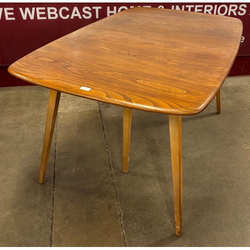 12 - An Ercol Blonde elm and beech Grand Windsor extending dining table