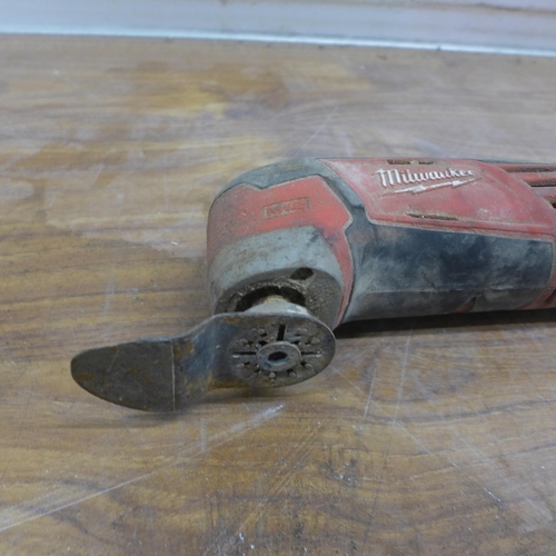 5058 - 2 Milwaukee power tools including a M18 hammer drill and a M12 multi tool