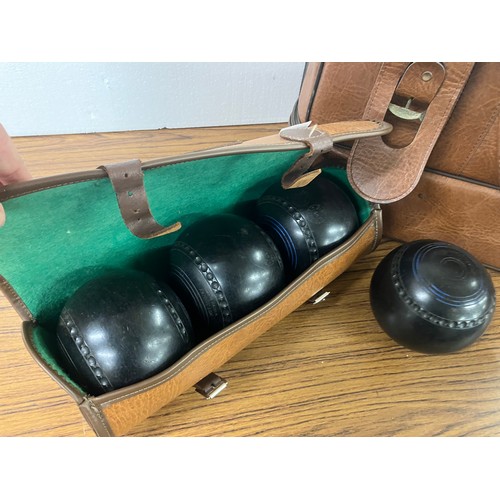 334 - Four bowling woods in a leatherette bowling bag