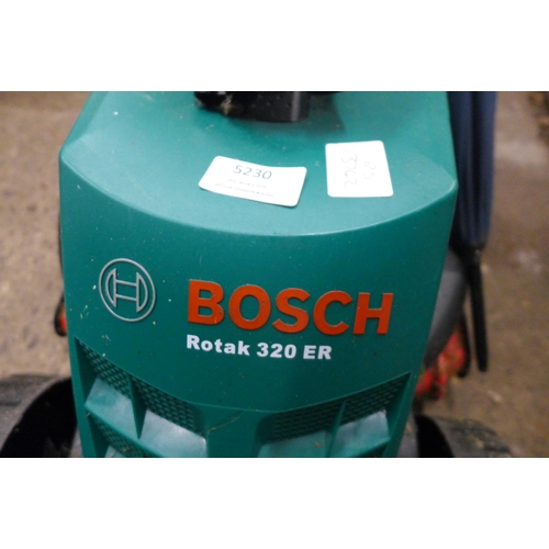 5230 - A Bosch Rotak 320 ER electric lawnmower and a Qualcast CHT51 cordless hedge cutter with charger