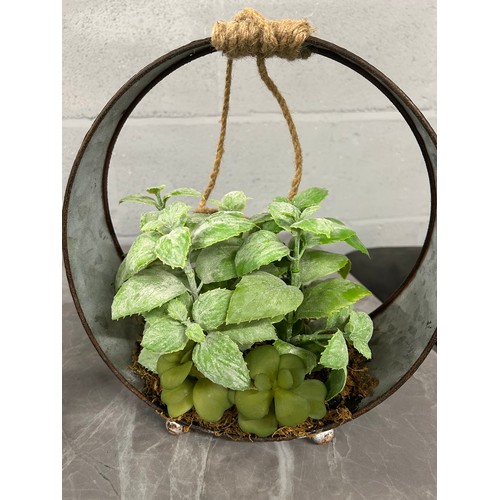 3132 - A pair of faux green succulents, in a round iron pot, (H 30cm)