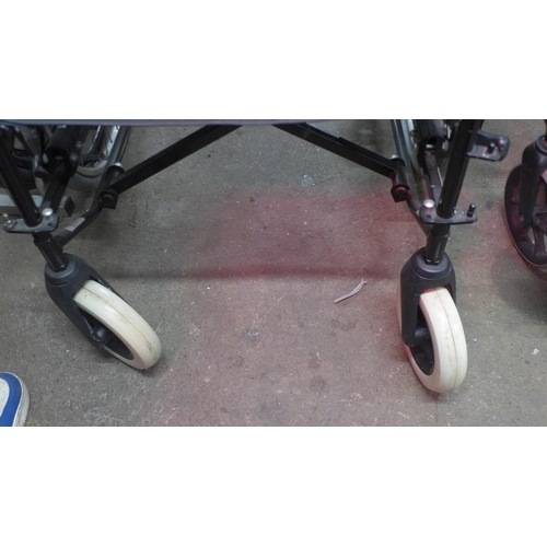 5154 - A large wheeled user operated wheelchair with footrest and seat cushion