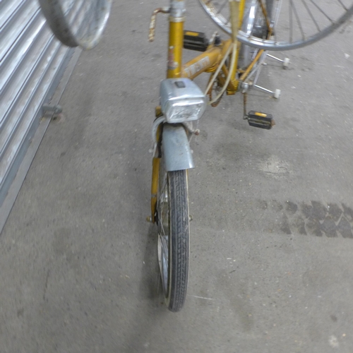 5168 - A vintage Raleigh Twenty folding bike with three spare wheels, front headlight, pannier rack and mud... 