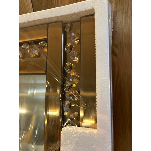 3244 - A bronze glass hall mirror with bevelled edge glass and border filled glass crystals, (120 x 40cm)