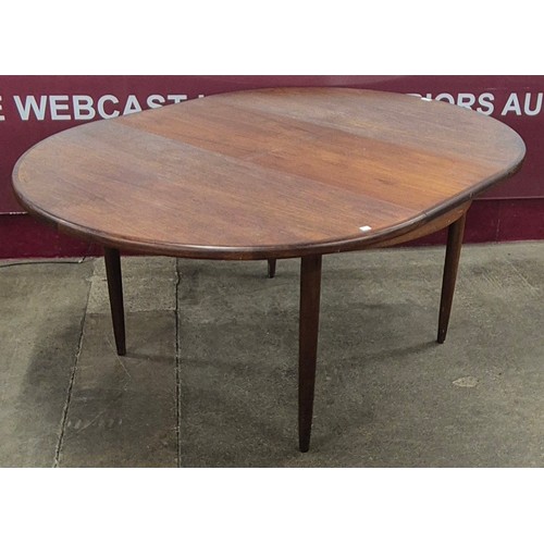 12 - A G-Plan Fresco teak circular extending dining table and four chairs