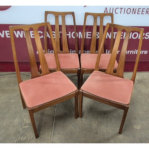 15 - A Nathan teak oval extending dining table and four chairs