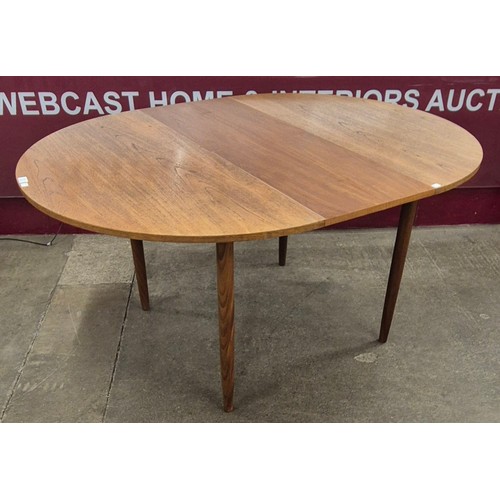 22 - A teak circular extending dining table