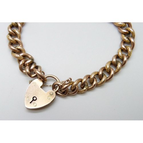 7001 - A 9ct gold gate bracelet with embossed design links, 10.5g