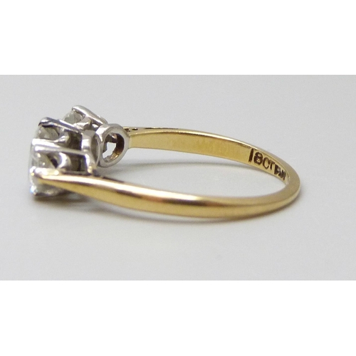 7005 - An 18ct gold and platinum set three stone diamond ring, inner shank engraved, 2.4g, K