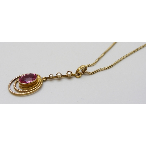 7020 - A gilt metal Edwardian drop pendant set with a paste stone and seed pearls, 3cm, on a 14ct gold chai... 