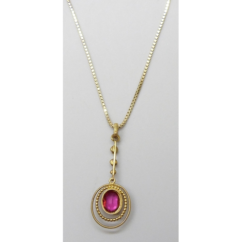 7020 - A gilt metal Edwardian drop pendant set with a paste stone and seed pearls, 3cm, on a 14ct gold chai... 