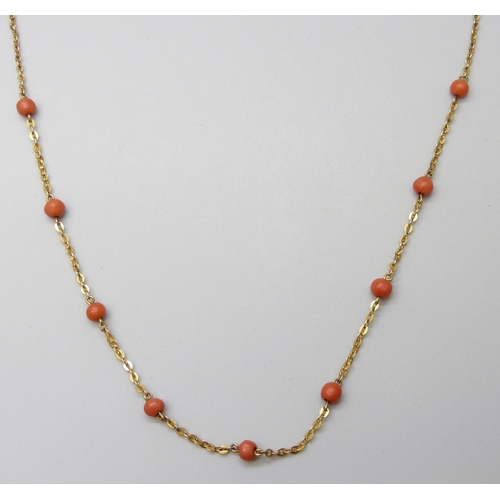 7025 - A 9ct gold necklace with coral beads, stamped 9C, 2.6g, 44cm