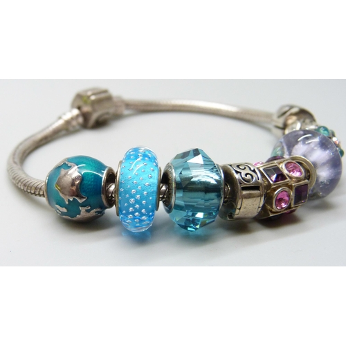 7038 - A silver Chamilia bracelet with nine silver Chamilia charms, a Swarovski charm and an unmarked charm... 