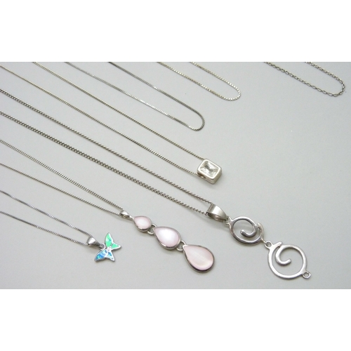 7044 - A collection of silver pendants and chains, and a plated pendant in packet, 28g