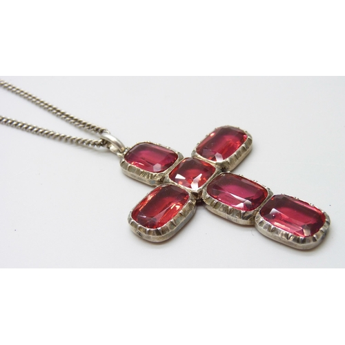 7047 - A vintage Georgian style silver and red paste stone cross pendant, tests as silver, on a long silver... 