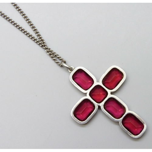 7047 - A vintage Georgian style silver and red paste stone cross pendant, tests as silver, on a long silver... 