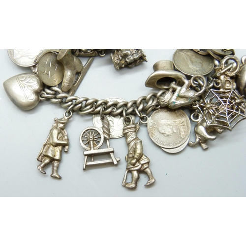 7052 - A silver Albert chain charm bracelet with 27 silver and white metal charms, 73g