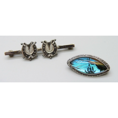 7054 - A collection of Victorian and later silver brooches, together with a silver napkin clip, 33g total