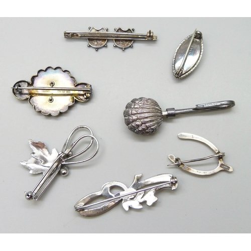 7054 - A collection of Victorian and later silver brooches, together with a silver napkin clip, 33g total