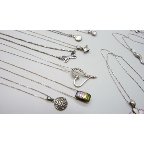 7060 - A collection of silver and white metal pendants and chains, 65g, together with a plated chain and a ... 