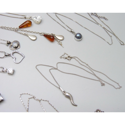 7060 - A collection of silver and white metal pendants and chains, 65g, together with a plated chain and a ... 