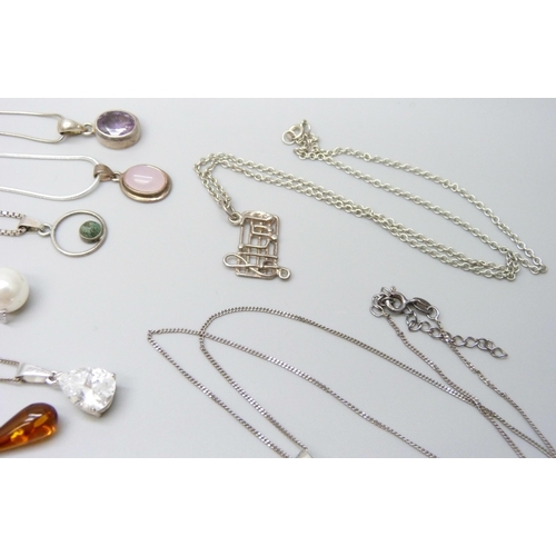 7060 - A collection of silver and white metal pendants and chains, 65g, together with a plated chain and a ... 