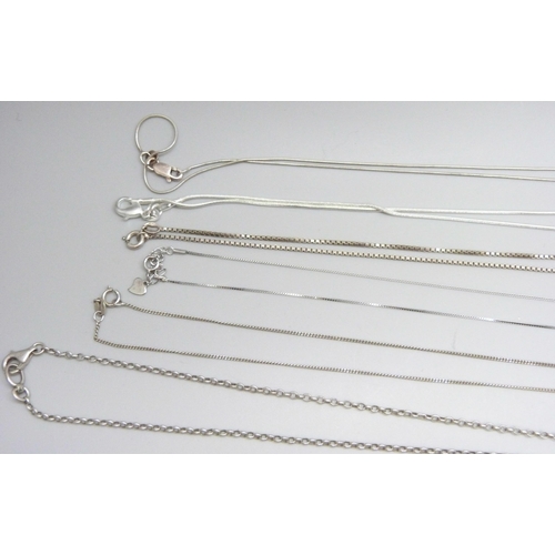 7060 - A collection of silver and white metal pendants and chains, 65g, together with a plated chain and a ... 