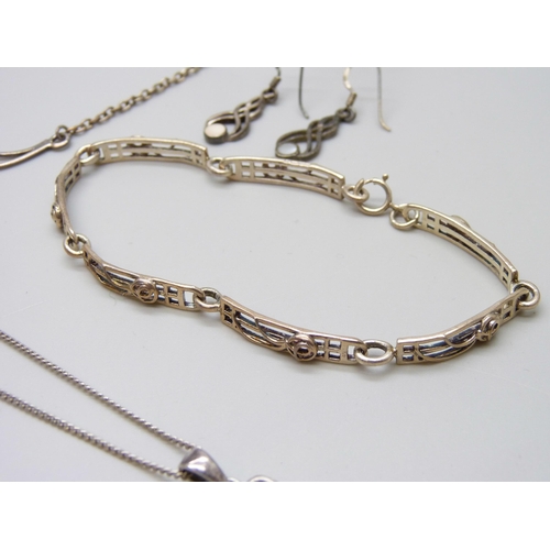 7063 - A collection of Rennie Mackintosh style silver jewellery - two bracelets, a bangle, two pendants on ... 