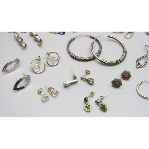 7064 - A collection of silver earrings, 52g, five pairs of unmarked white metal earrings, a pair of costume... 