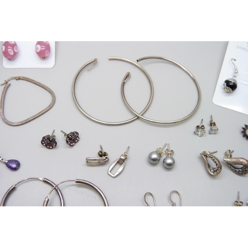 7064 - A collection of silver earrings, 52g, five pairs of unmarked white metal earrings, a pair of costume... 