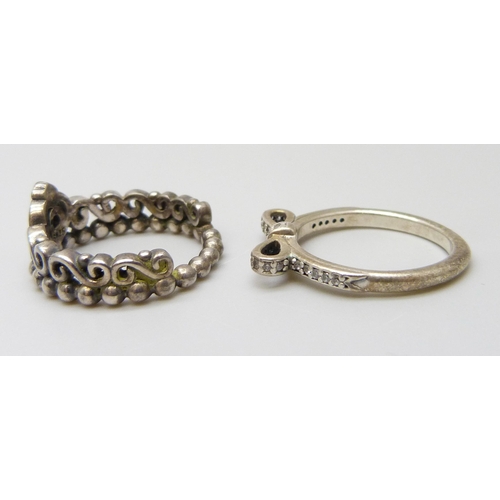 7067 - Two silver Pandora rings, both size L, and a pair of silver Pandora earrings