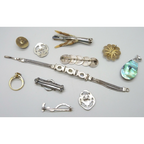 7070 - A silver set moonstone bracelet, two silver buttons, a Victorian silver bar brooch, a silver gilt ri... 