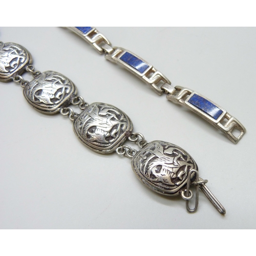 7083 - A white metal panel bracelet depicting mythical beasts, together with a silver lapis lazuli bracelet... 