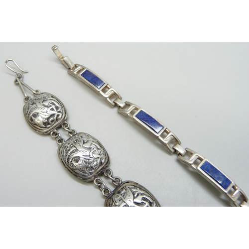 7083 - A white metal panel bracelet depicting mythical beasts, together with a silver lapis lazuli bracelet... 