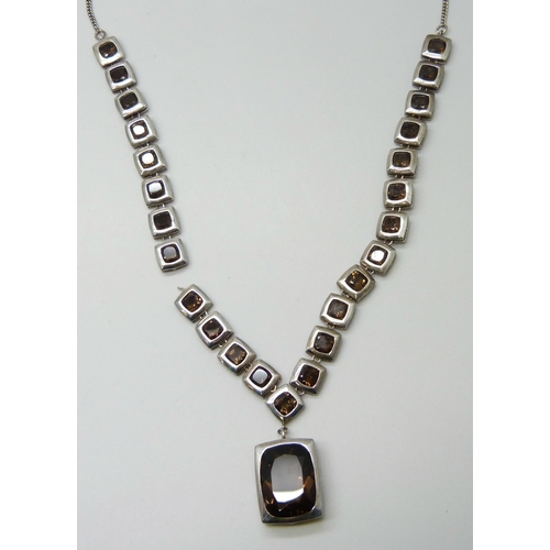 7085 - A silver and smoky quartz necklace, (requires repair in two places - detached on both sides), 37g