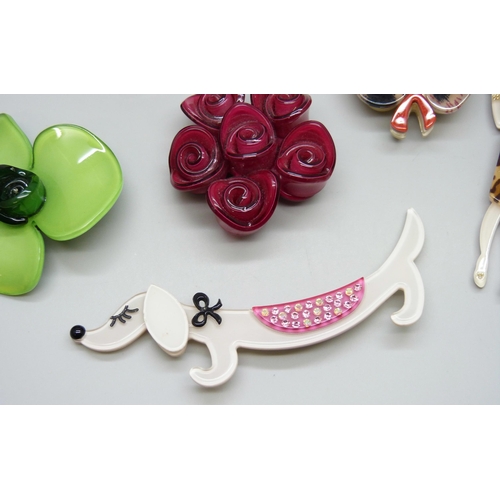 7093 - A collection of plastic jewellery including an Art Deco style lady and a 1960s style lady, dog brooc... 