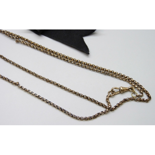 7094 - A Victorian gold filled long guard chain, together with a rolled gold buckle/dog clip ribbon, 130cm ... 