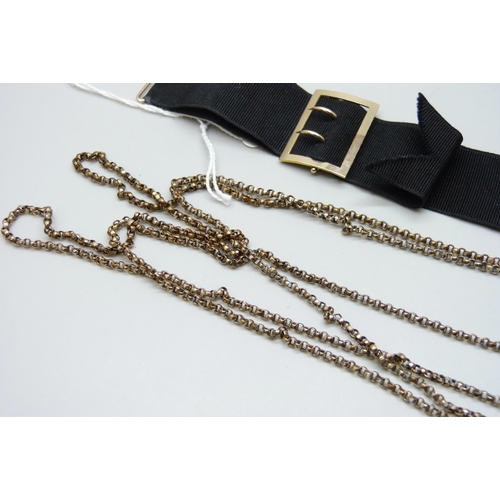 7094 - A Victorian gold filled long guard chain, together with a rolled gold buckle/dog clip ribbon, 130cm ... 