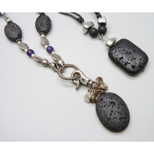 7100 - Two lava stone necklaces, one set with amethysts