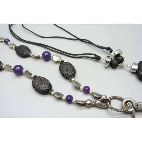 7100 - Two lava stone necklaces, one set with amethysts