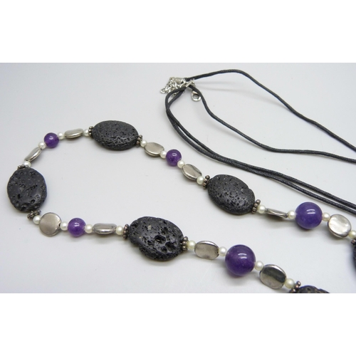 7100 - Two lava stone necklaces, one set with amethysts