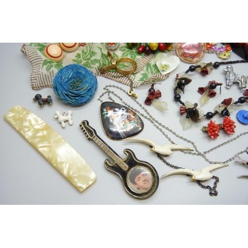 7107 - A collection of plastic and other vintage jewellery including The Beatles Paul McCartney guitar broo... 