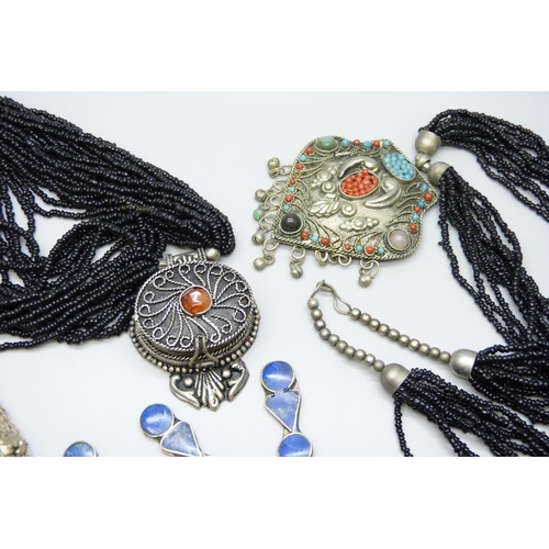 7116 - Four Eastern style necklaces including one set with lapis lazuli